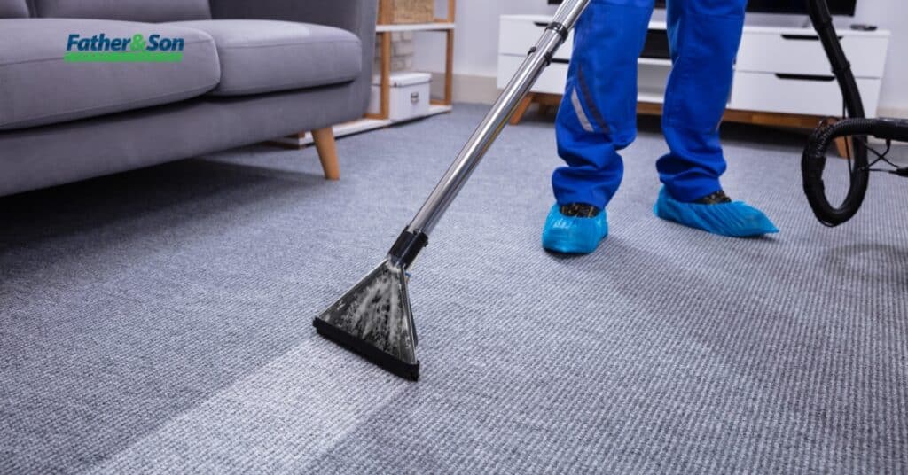 Professional carpet cleaner using a steam extractor in a living room