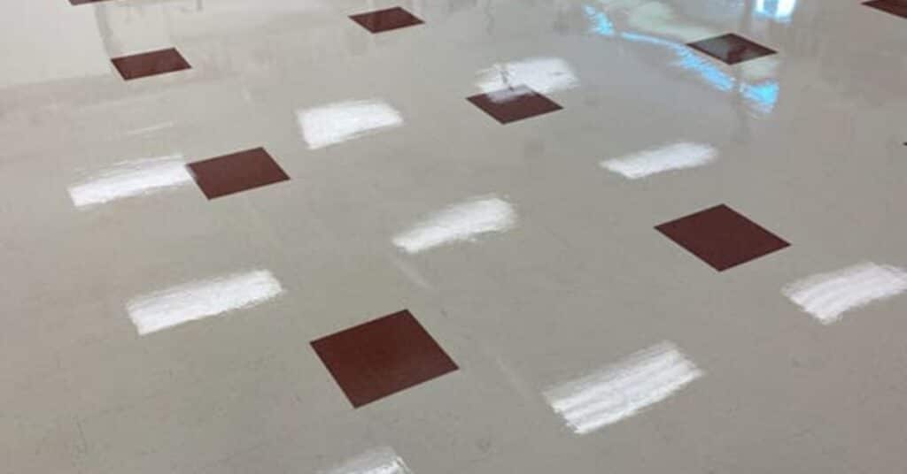 Professional technician stripping and waxing VCT floor in Utah business location