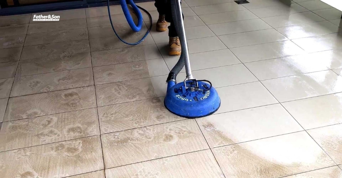 Homeowner inspecting tile and grout lines for dirt buildup