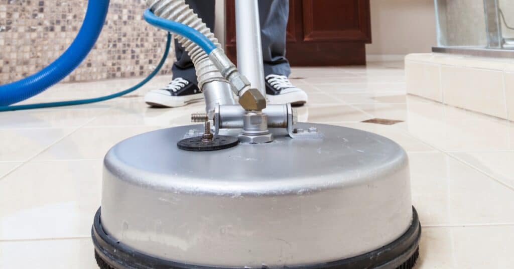 Technician performing tile and grout cleaning in Utah home