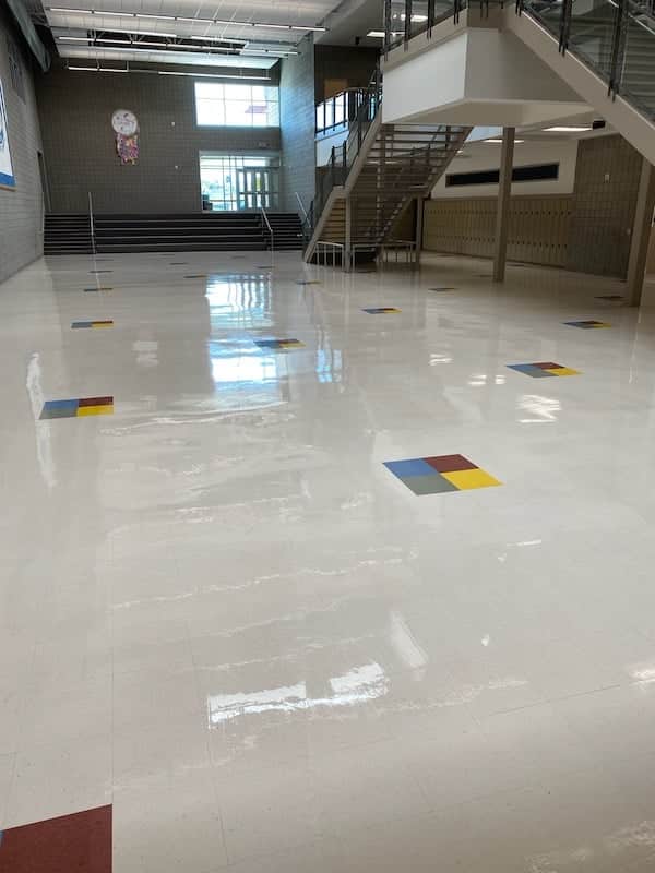 A school building with a colorful VCT floor and stairs.